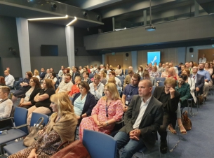 uczestnicy spotkania siedzą na sali 